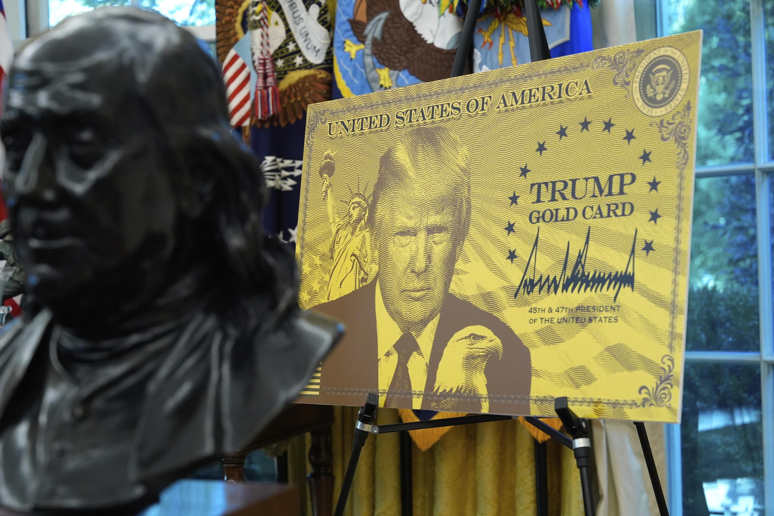 Donald Trump stands in the Oval Office next to a giant replica of the $1 million ‘Gold Card’ visa, symbolizing his new fast-track U.S. residency program for wealthy foreigners.