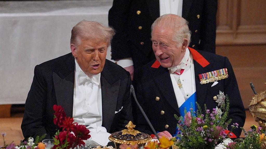 Donald Trump with King Charles III during a recent state visit to the United Kingdom, both leaders appearing formal during an outdoor ceremony.