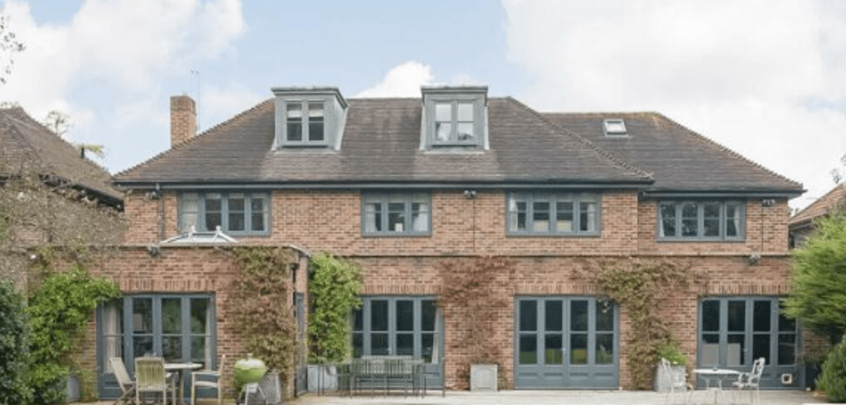 Exterior of Huw Edwards’ six-bedroom Dulwich Village home, a large mid-century property with landscaped front garden.