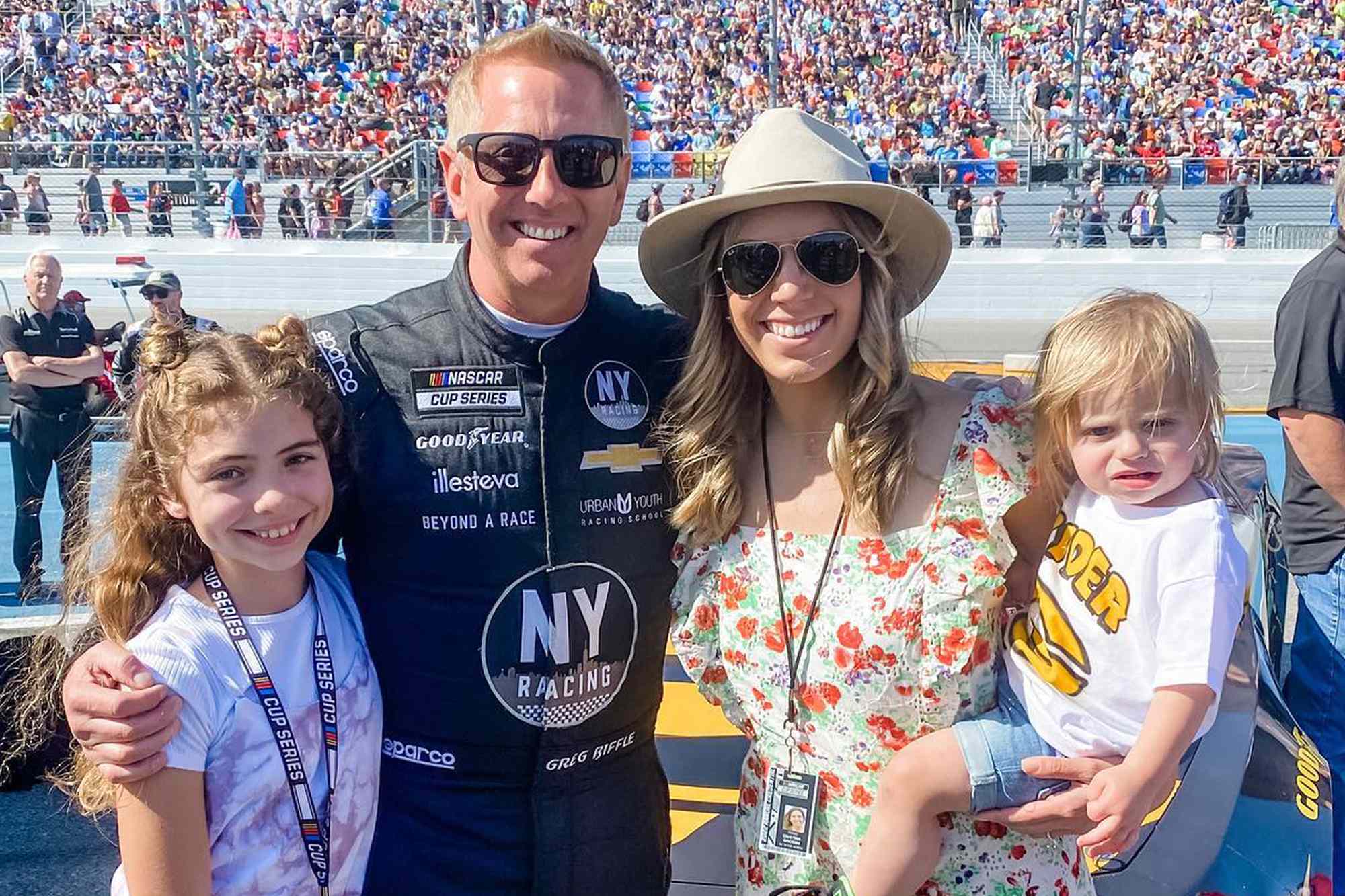 Greg Biffle smiling alongside his wife Cristina and children Emma and Ryder in a family photo taken away from the racetrack.