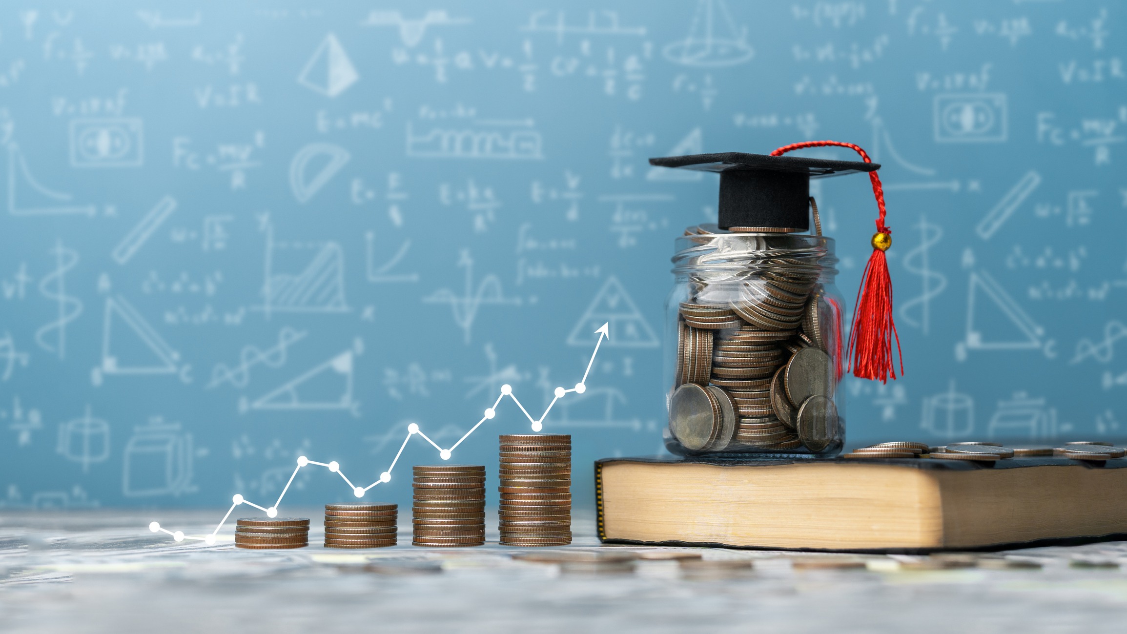 concept student success scholarships, students for college and university tuition, tuition for education, investment and scholarships. stack of coins on a book with a graph and a graduation cap