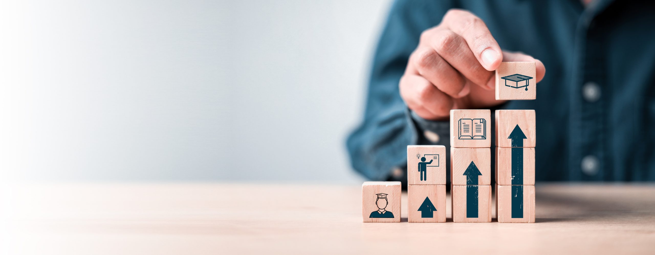 student icons on wooden blocks. education concept for success.