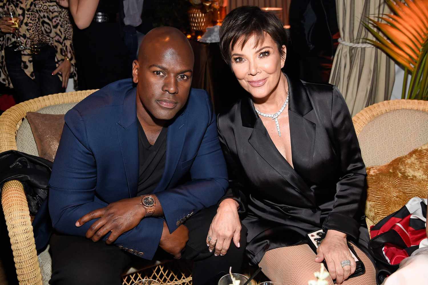 Kris Jenner and Corey Gamble sitting side by side, smiling for a posed photograph.