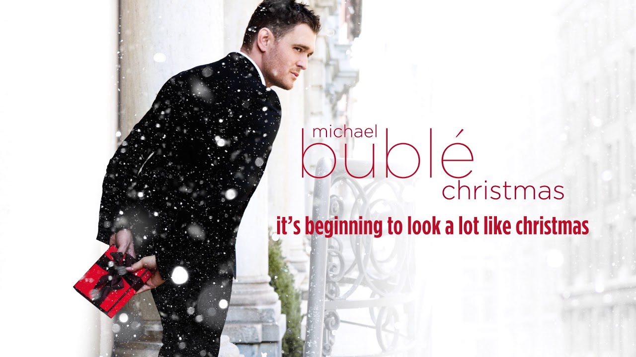Michael Bublé’s Christmas album cover featuring a festive portrait of the singer in a cozy, holiday-themed setting.