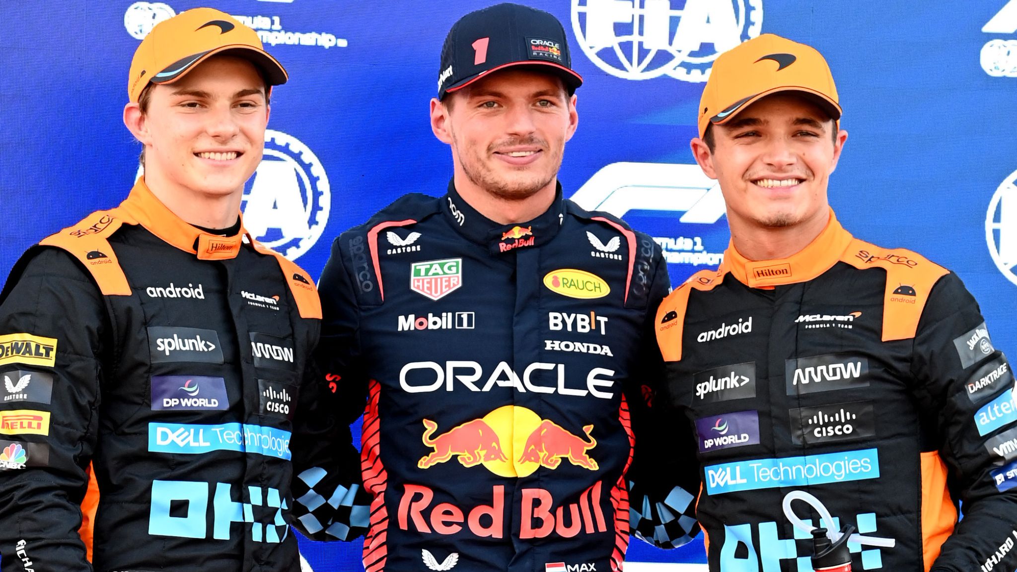 Lando Norris, Max Verstappen, and Oscar Piastri standing side by side for a pre-race photo, capturing the tension of the three-way Formula 1 title fight ahead of the Abu Dhabi showdown.