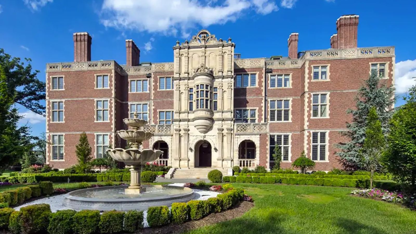 Front exterior of Miles Guo’s Gilded Age New Jersey mansion, showing the sprawling historic estate later seized following his fraud conviction.