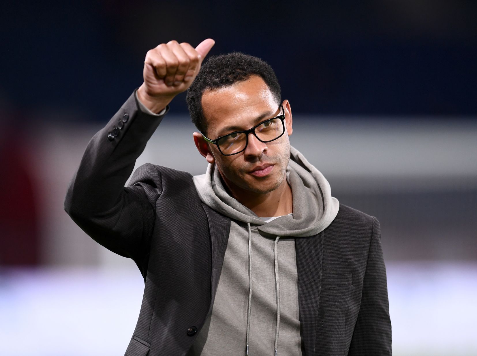 Chelsea’s new head coach Liam Rosenior giving a thumbs-up to the crowd during a Strasbourg match, acknowledging fans and showing support.