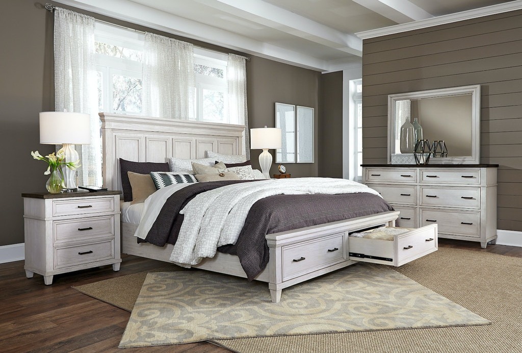 A bedroom featuring a matching bed, nightstands, and dresser in a coordinated style.