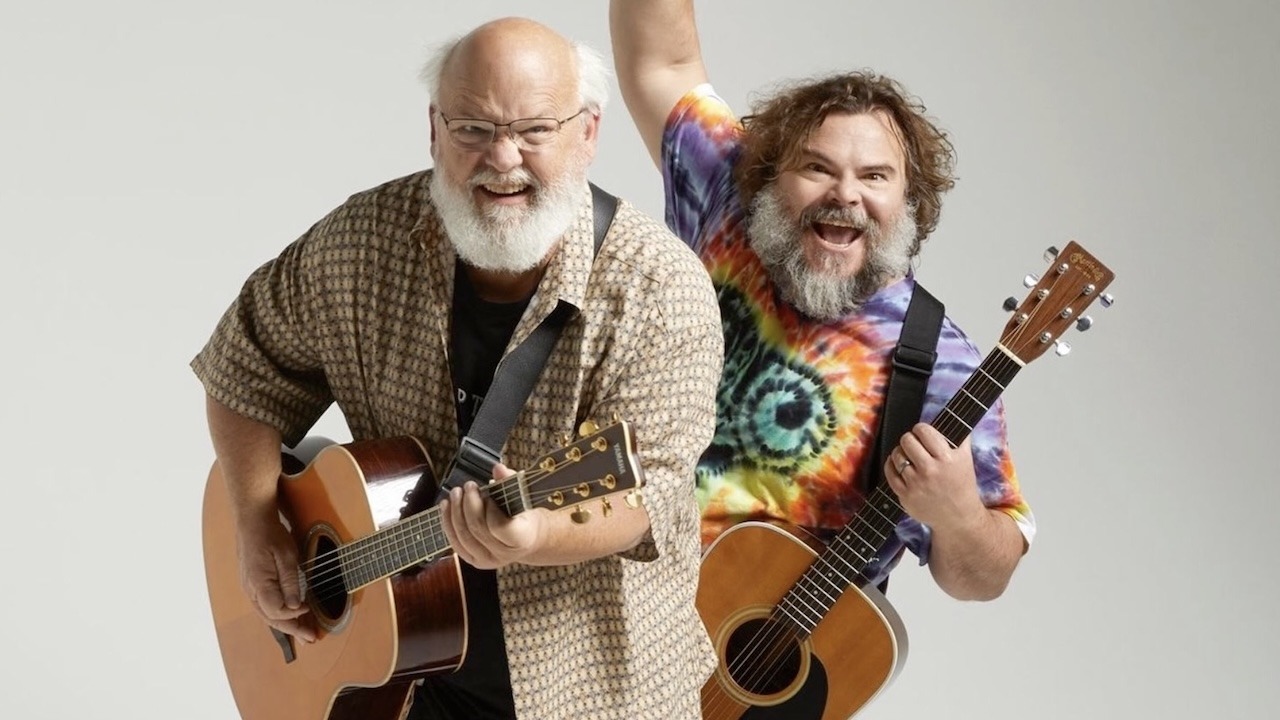 Tenacious D members Kyle Gass and Jack Black posing with their guitars during a promotional photo shoot, showcasing their iconic rock duo image.