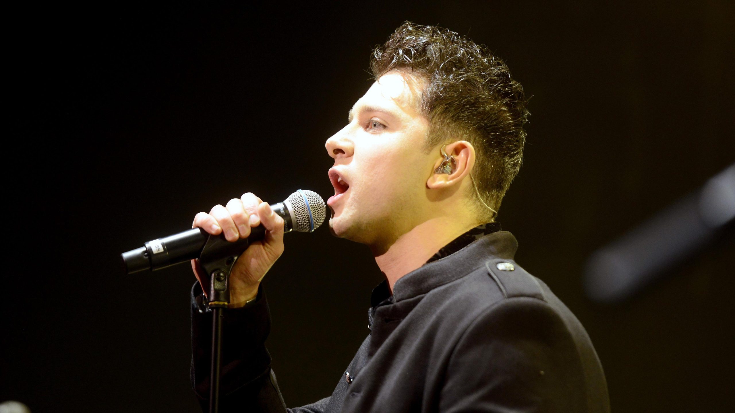 Ross Davidson singing on stage during his time with Spandau Ballet, performing live in front of a cheering audience.