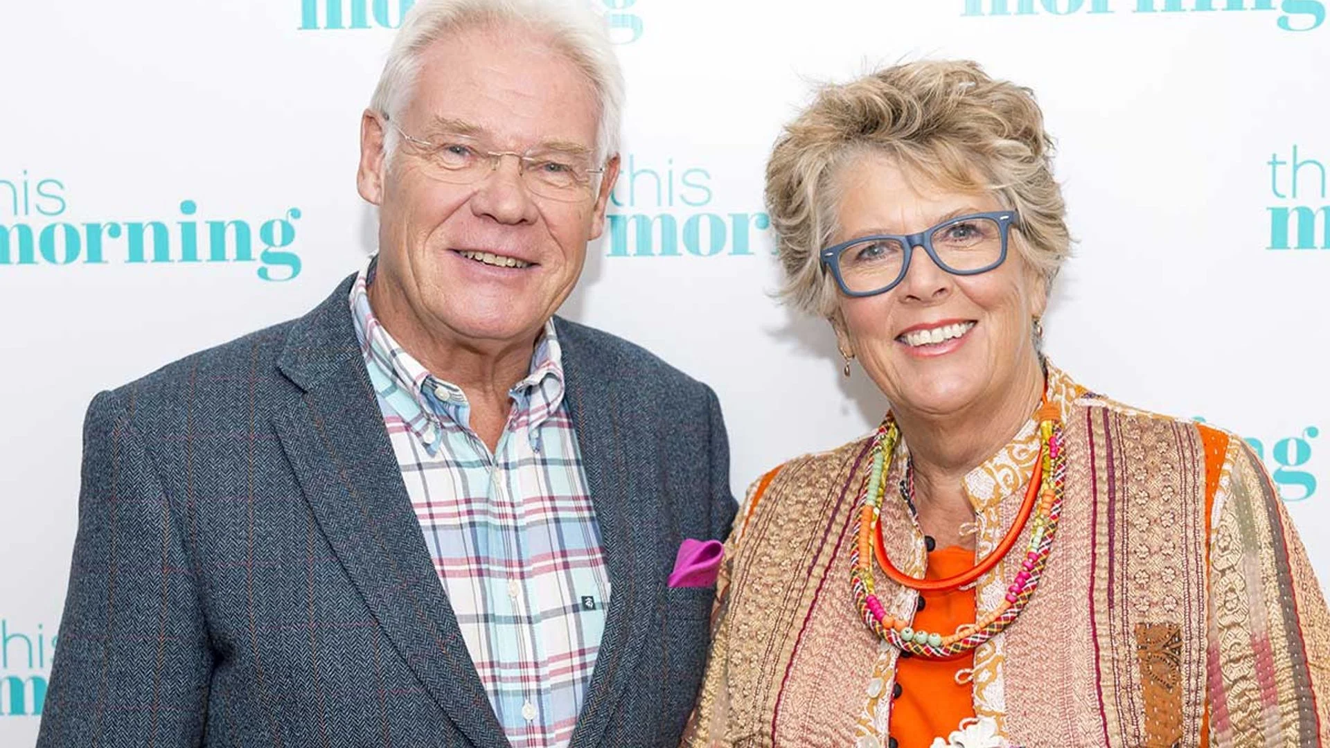 Prue Leith and her husband John Playfair smiling together on the ITV red carpet, dressed elegantly and enjoying the event.