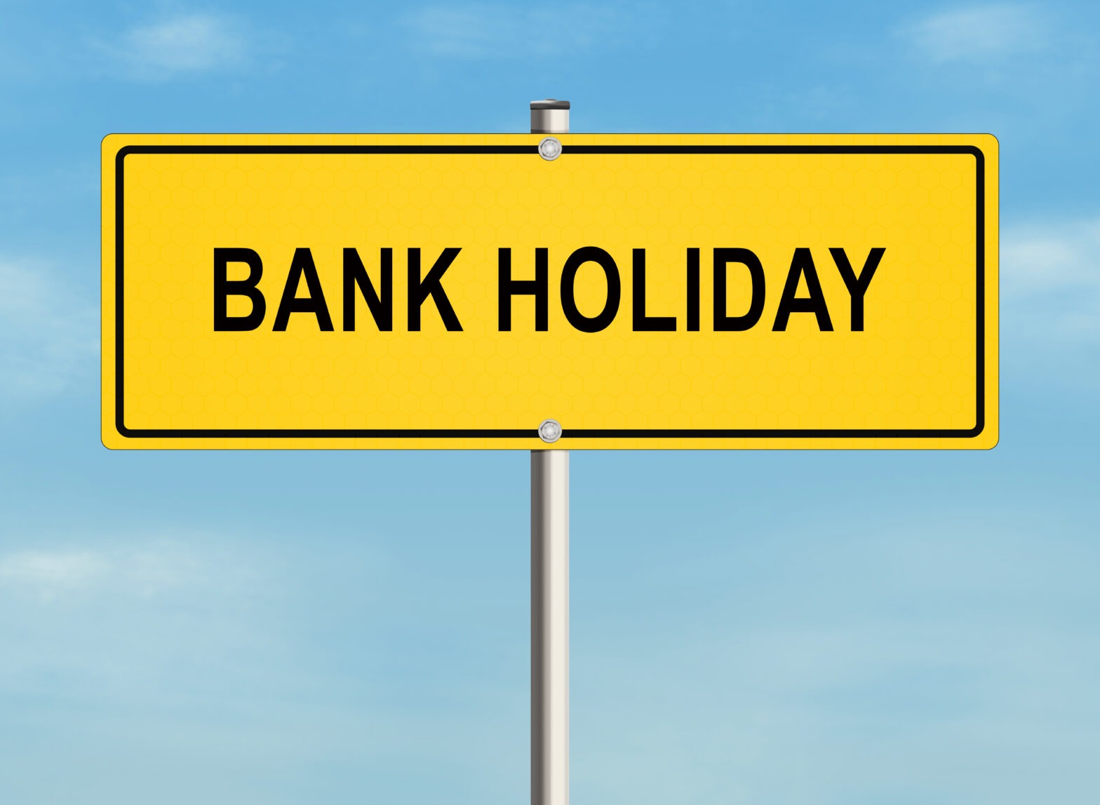 Bright yellow sign displaying “Bank Holiday” in bold letters, symbolizing public holidays and time off work in the UK.