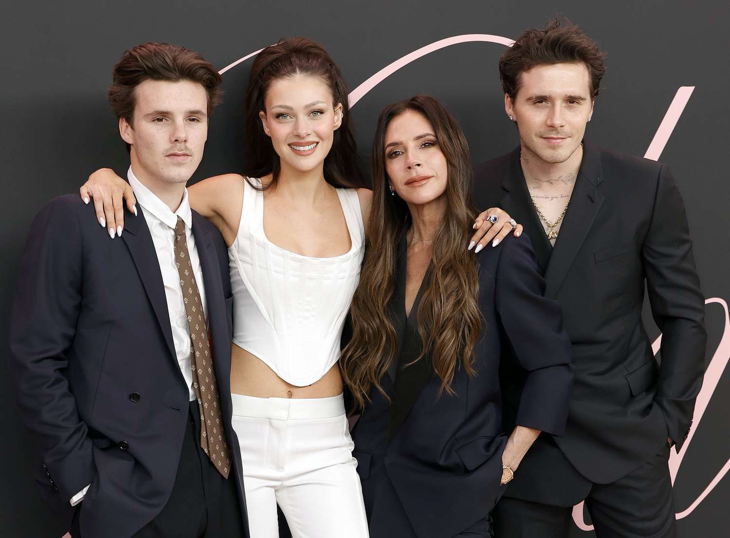 Nicola Peltz, Brooklyn Beckham and Victoria Beckham pose together on the red carpet at a public event