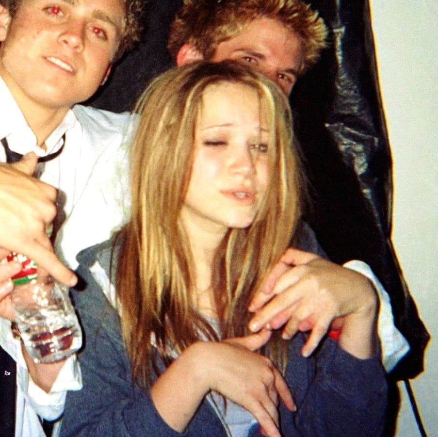 Mary-Kate Olsen appears unsteady while standing with Spencer Pratt and her then boyfriend in a candid tabloid-era photo taken during a night out.