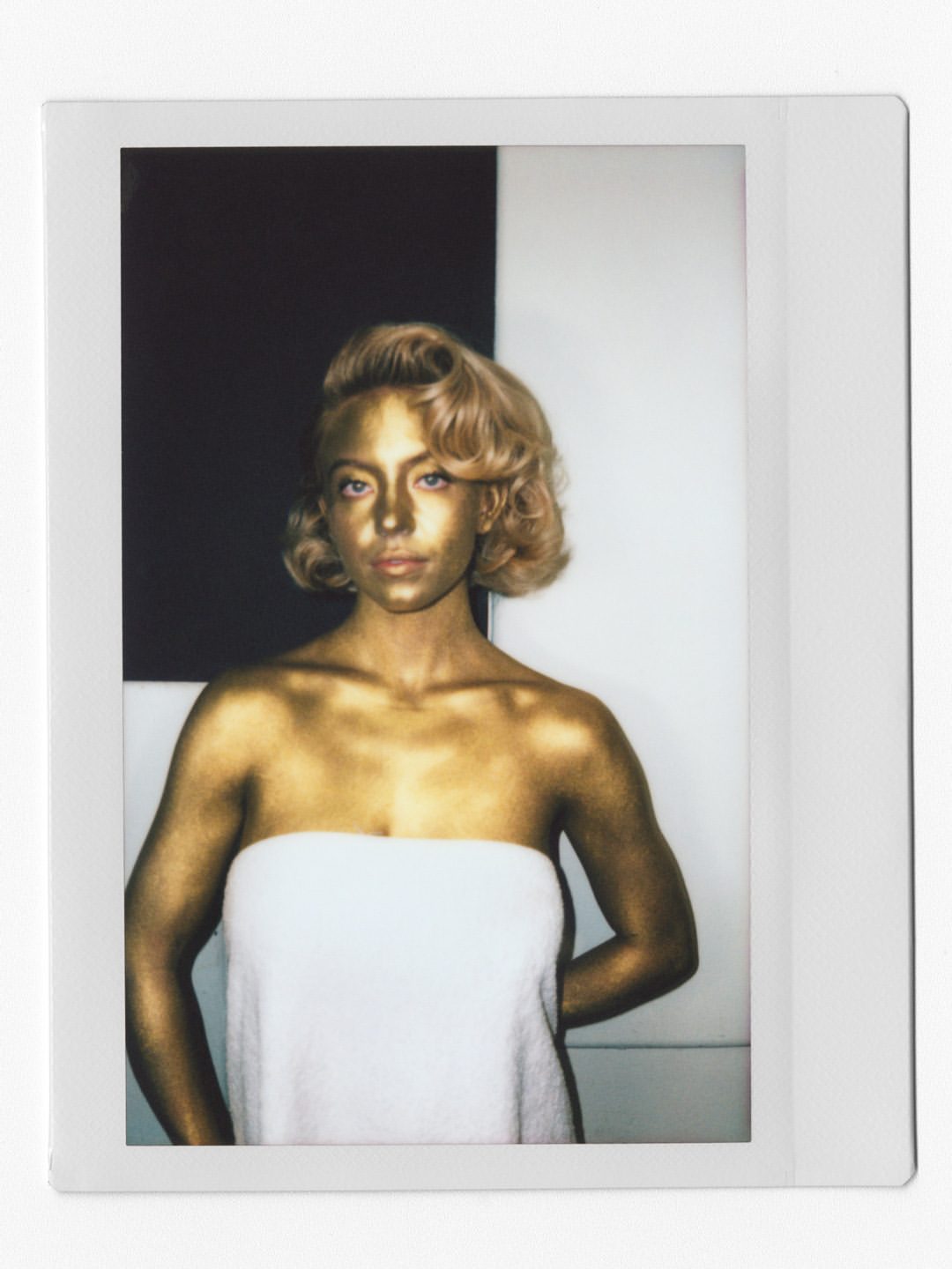 Sydney Sweeney poses draped in a gold towel during her W Magazine 2026 shoot, showcasing Old Hollywood glamour and elegance