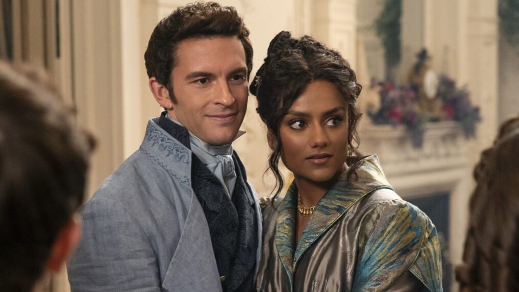 Jonathan Bailey as Anthony Bridgerton embracing Kate Sharma inside the Bridgerton manor in a romantic Regency-era scene.