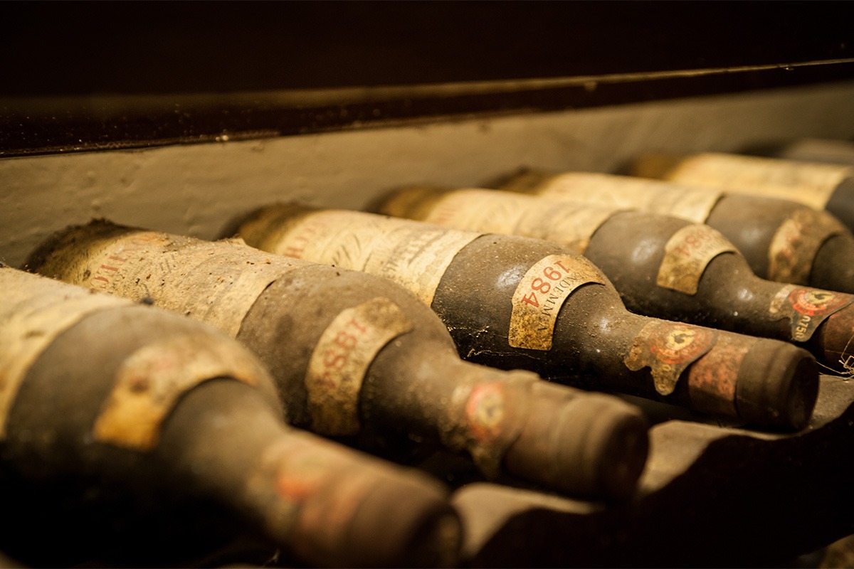 Rare vintage wine bottle valued at hundreds of thousands of dollars displayed in a cellar