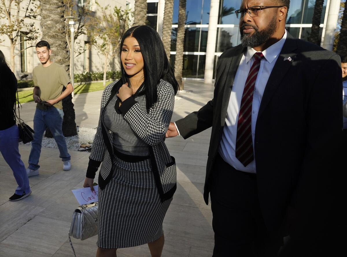 Cardi B smiles as she leaves the Los Angeles courthouse following the jury verdict in her civil trial.