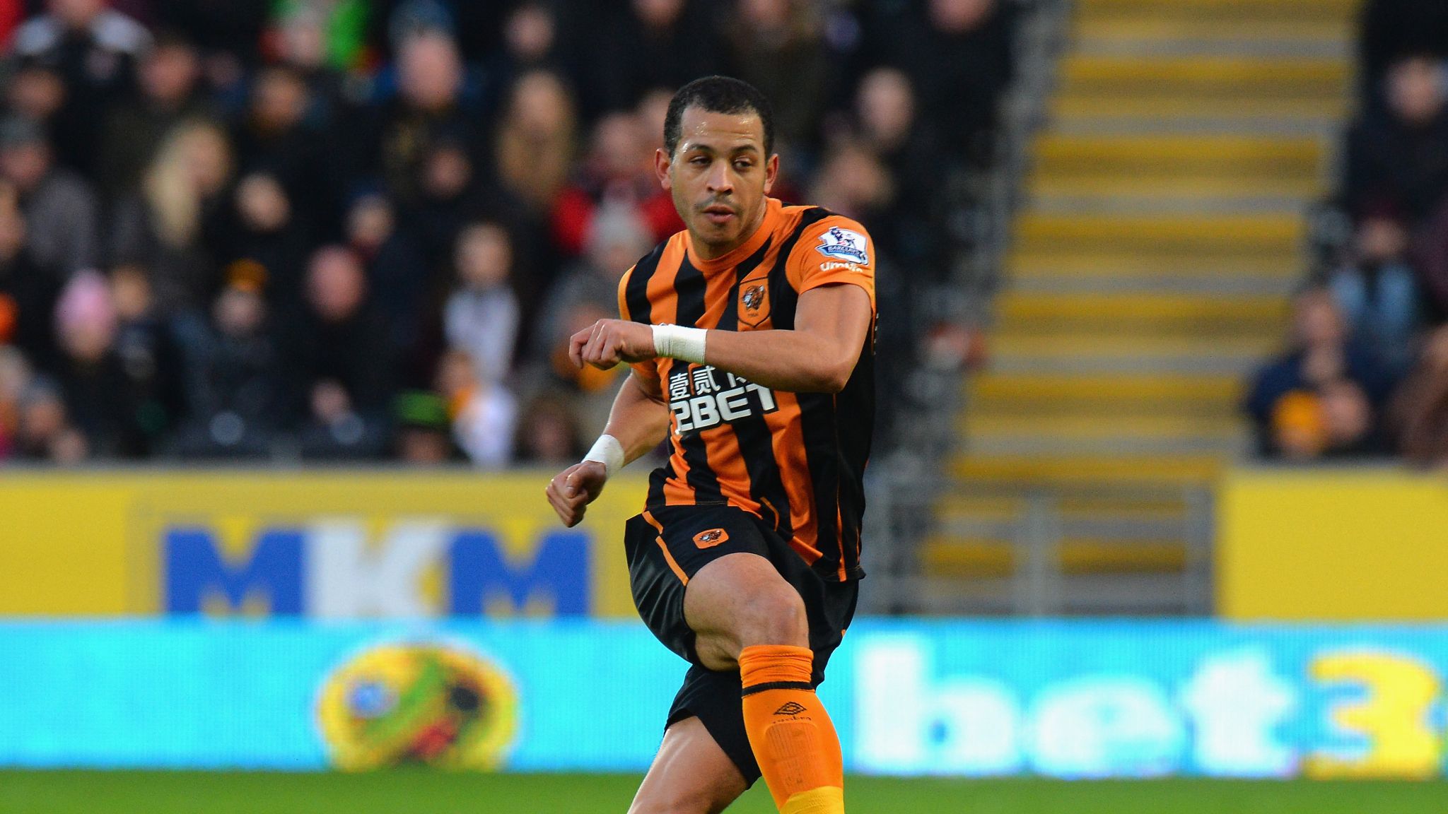 Liam Rosenior in action playing for Hull City, dribbling the ball during a football match.