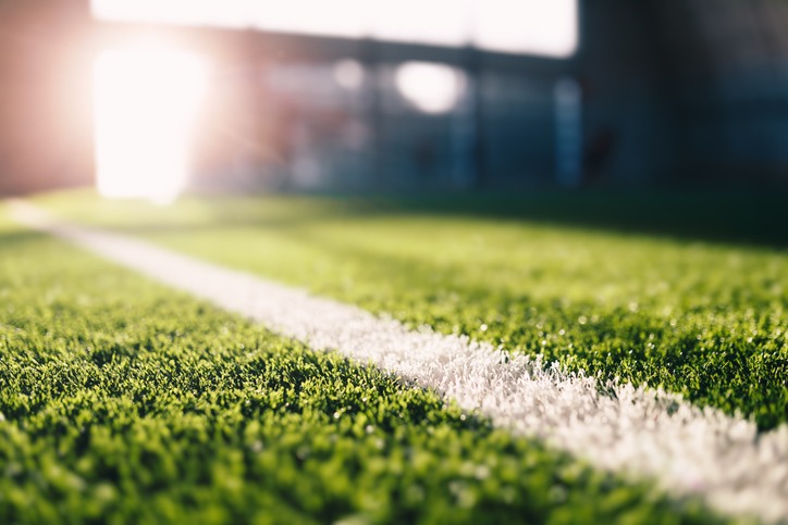 soccer field sideline at sunny day. summer day at sports field. sunlight in the background. soccer pitch background.