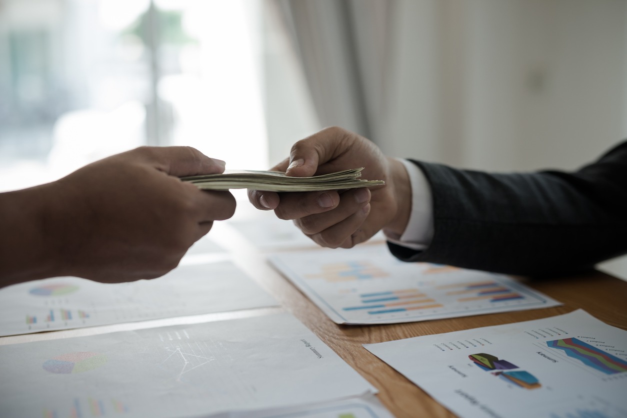men's hands, sending money to business travelers. corruption and bribery concept