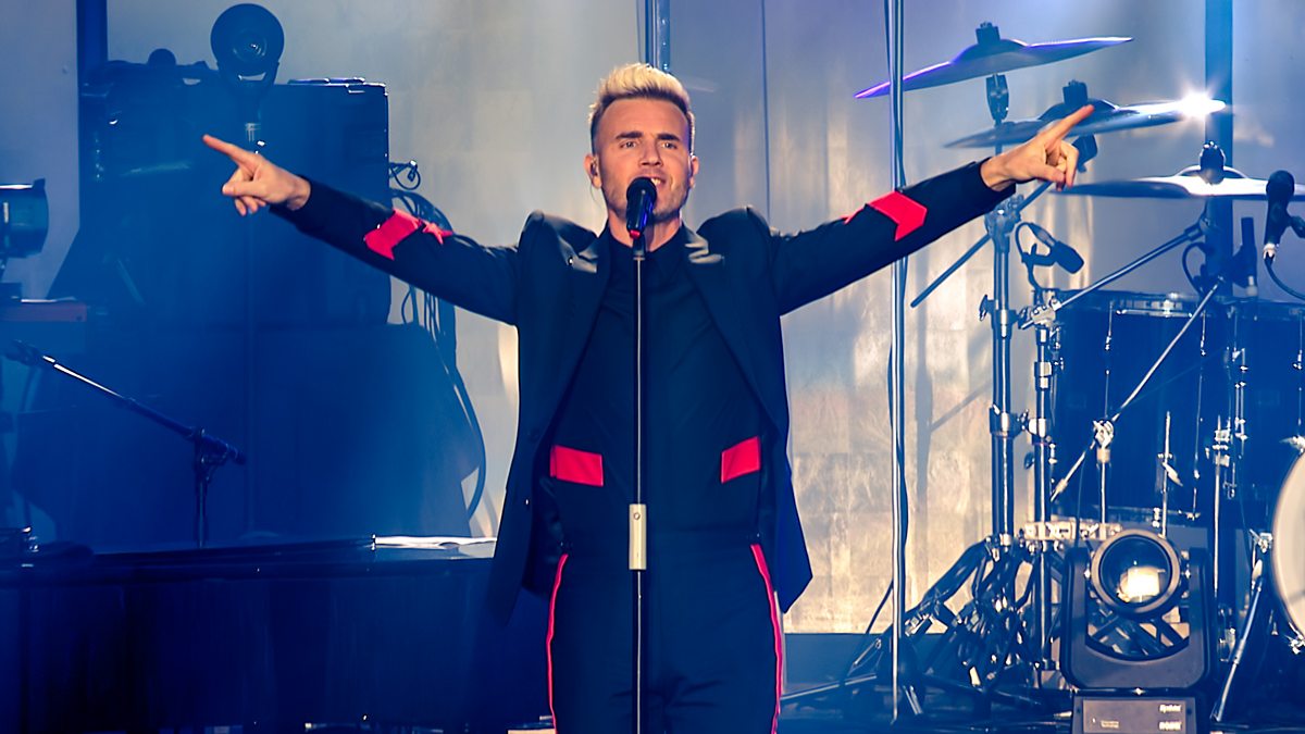 Gary Barlow with arms outstretched performing on stage during a Take That concert