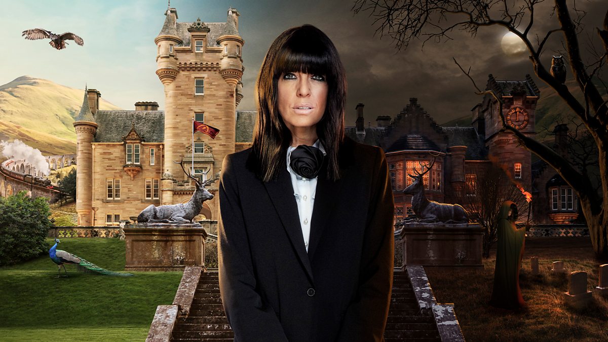 Claudia Winkleman stands in front of the castle used as the filming location for the BBC reality series The Traitors.