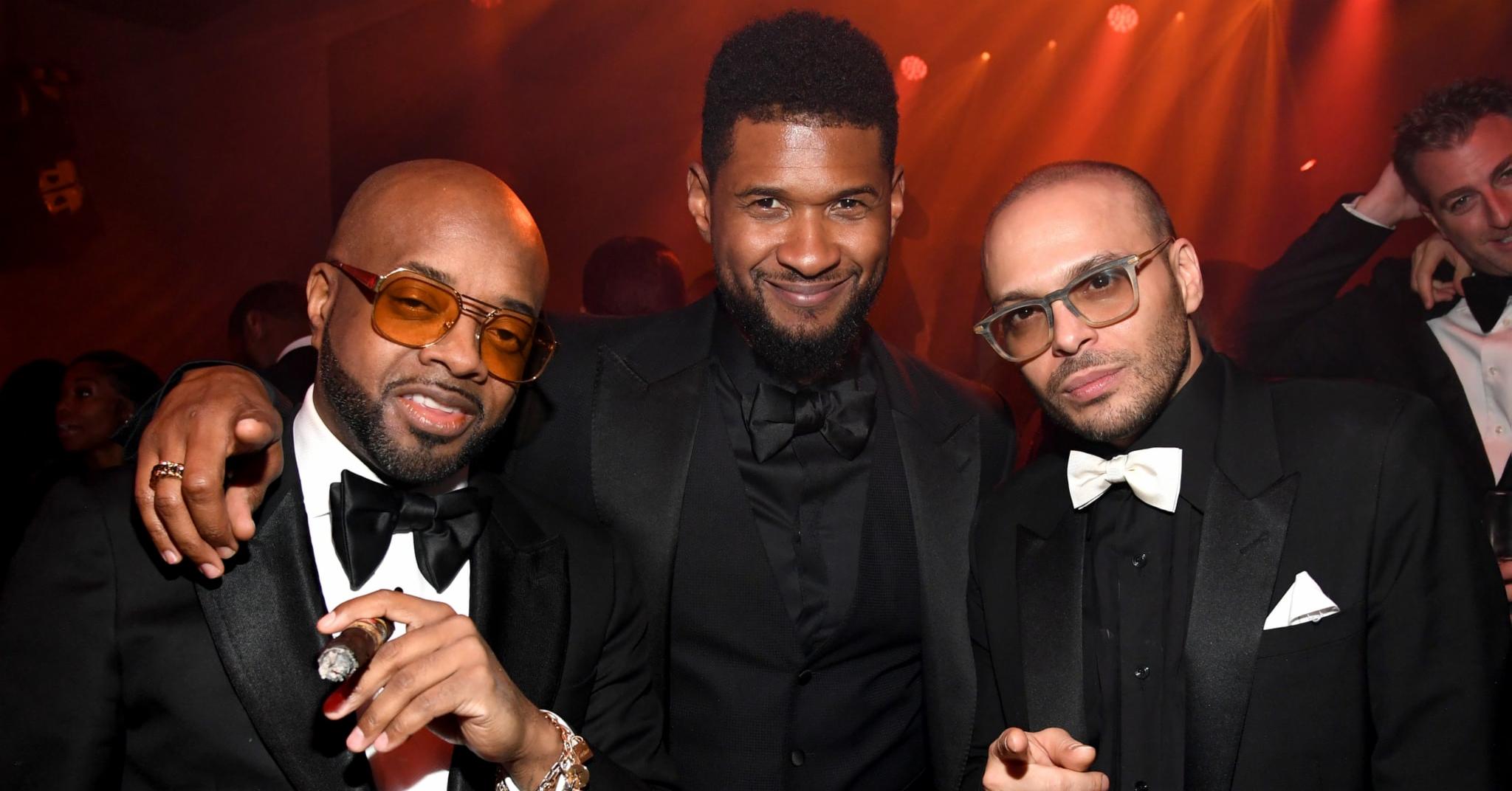 Richie Akiva posing alongside singer Usher, both smiling for the camera at an event.