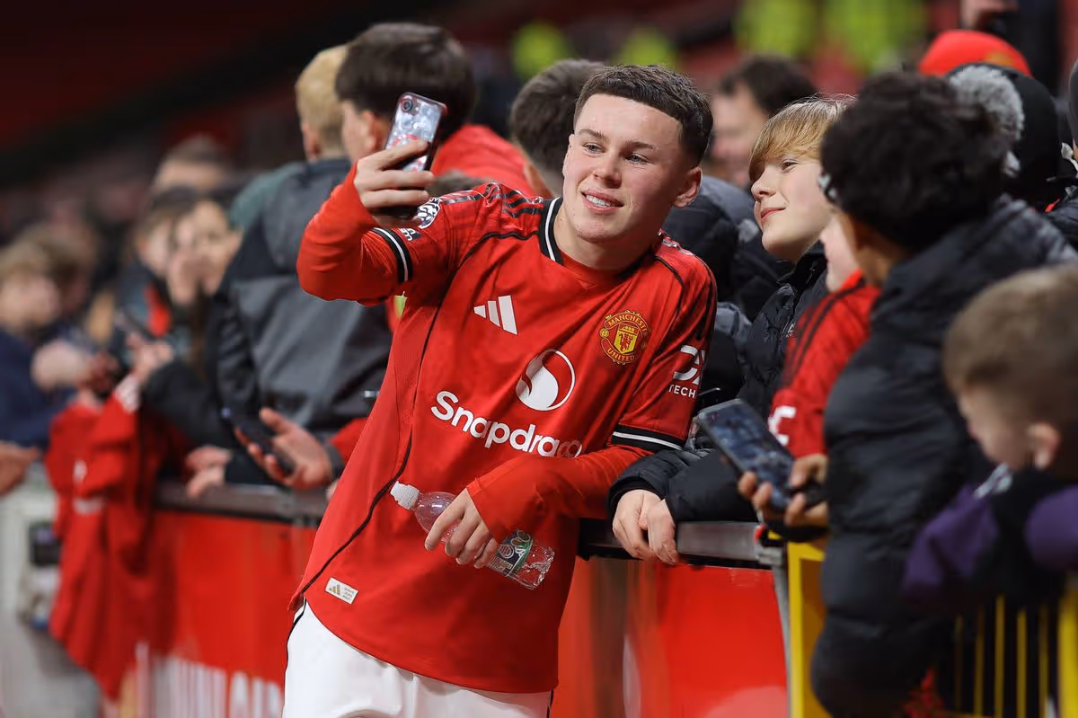 Kai Rooney smiling and taking selfies with fans inside Old Trafford after his memorable FA Youth Cup appearance.