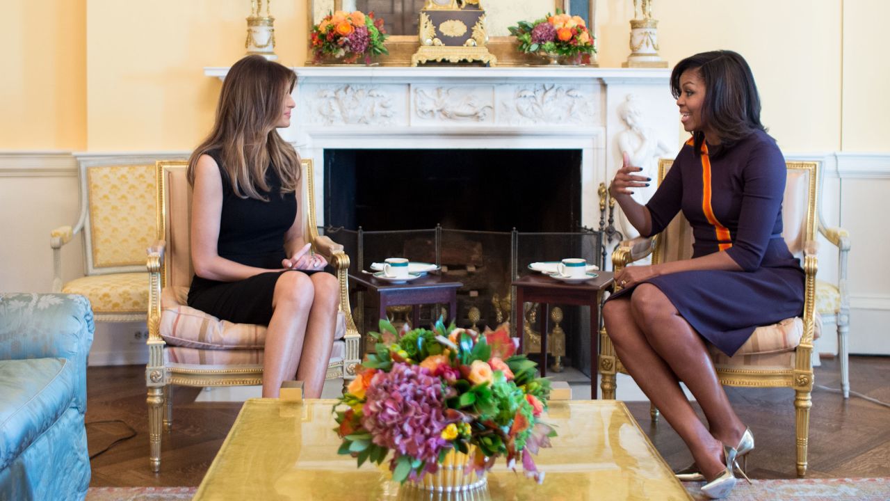 Melania Trump and Michelle Obama sit together in the White House, engaged in conversation during a public appearance several years ago.