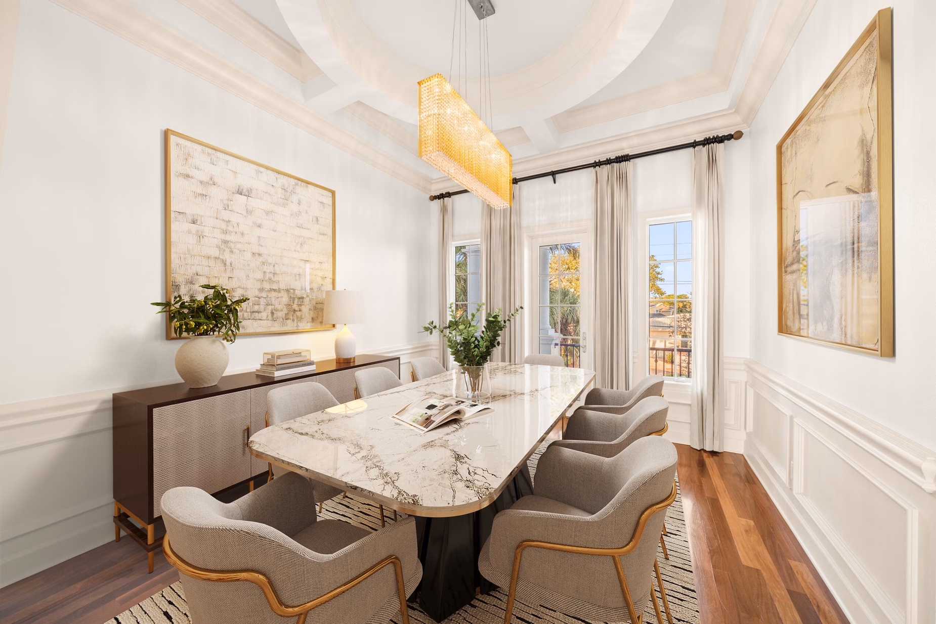 Elegant dining room in Hulk Hogan’s Clearwater mansion, showcasing a marble table, designer chairs, and floor-to-ceiling windows with Gulf views.