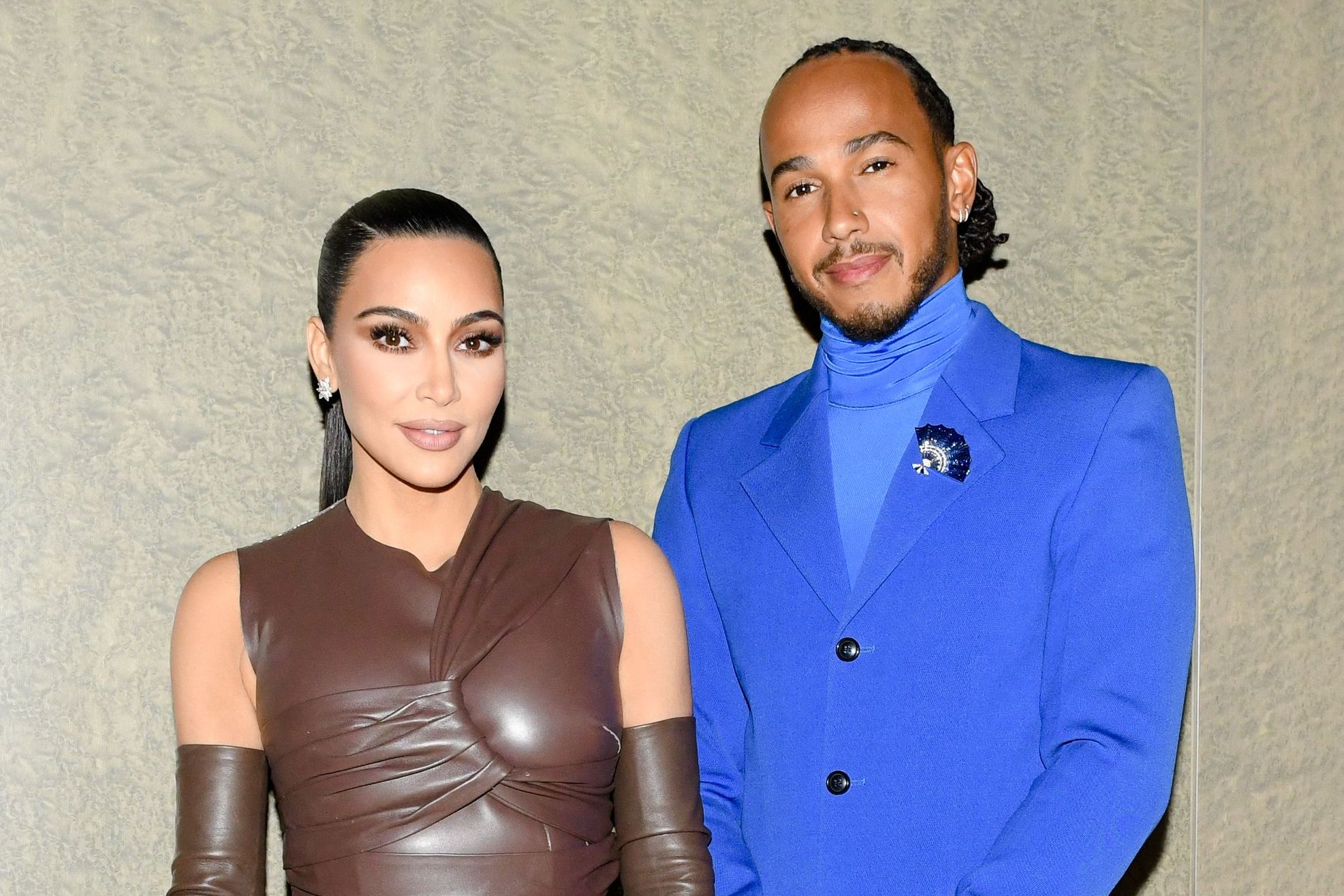 Kim Kardashian and Lewis Hamilton pose together during a night out, showcasing their budding romance and high-profile celebrity style.