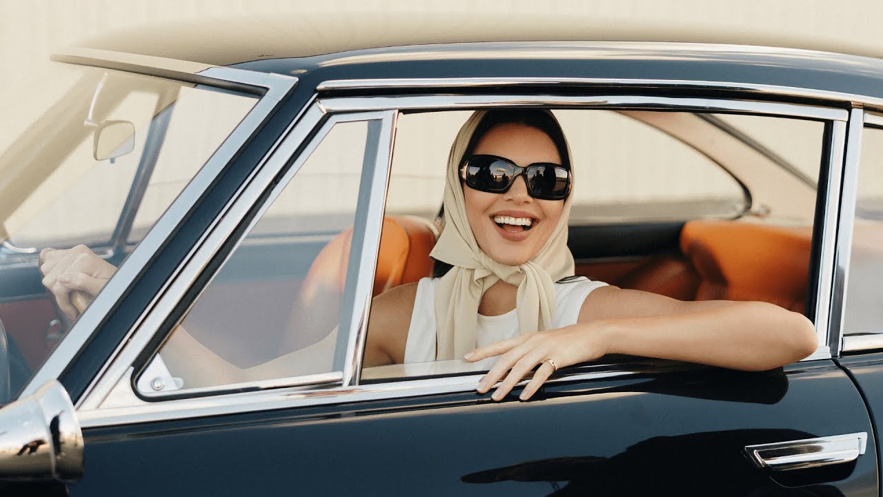 Kendall Jenner in a Fanatics Sportsbook Super Bowl ad, smiling and speaking directly to the camera on set.