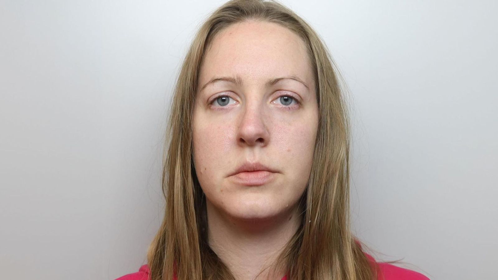 Mugshot of Lucy Letby taken at the time of her 2020 arrest, showing her in police custody with a neutral expression.