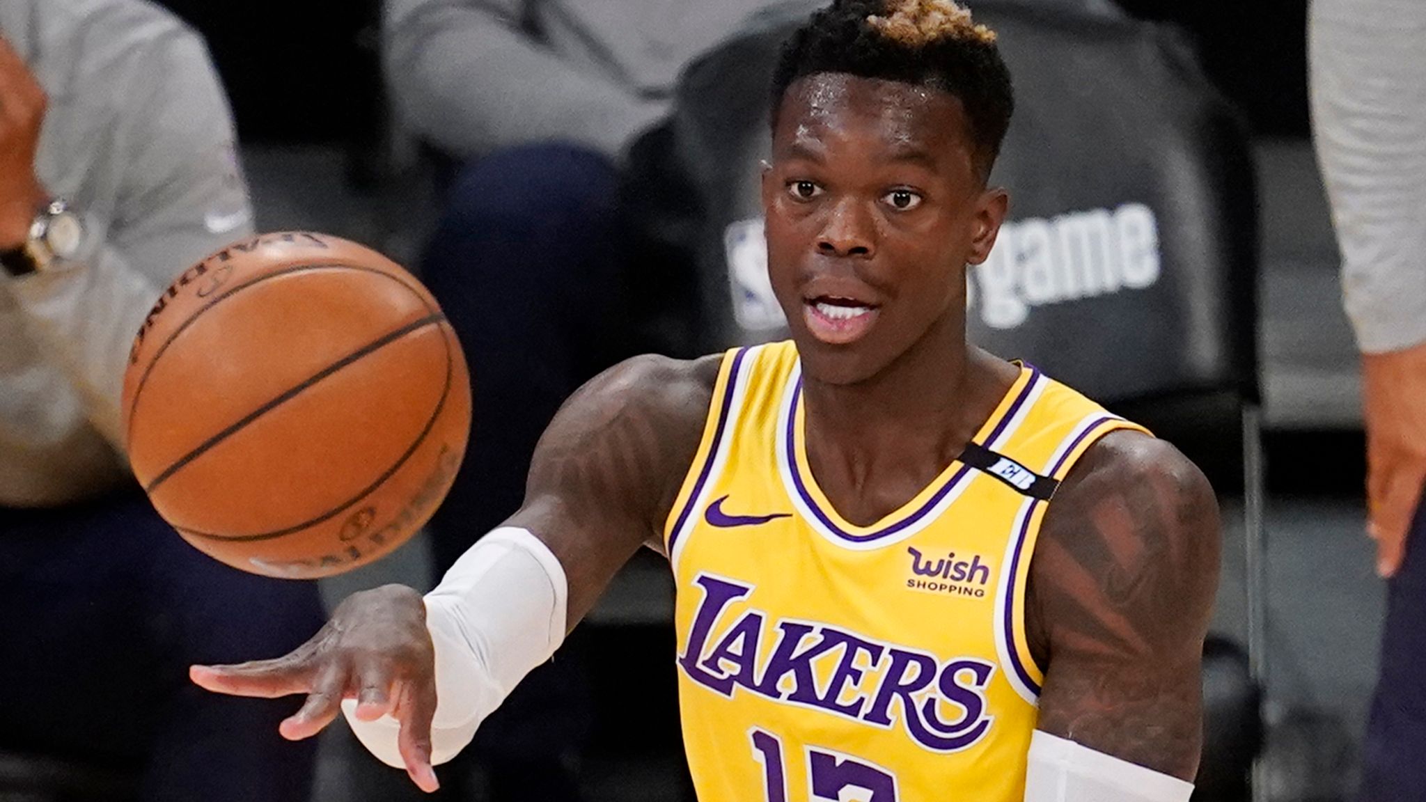 Dennis Schroder dribbling the basketball in a Los Angeles Lakers uniform during an NBA game.
