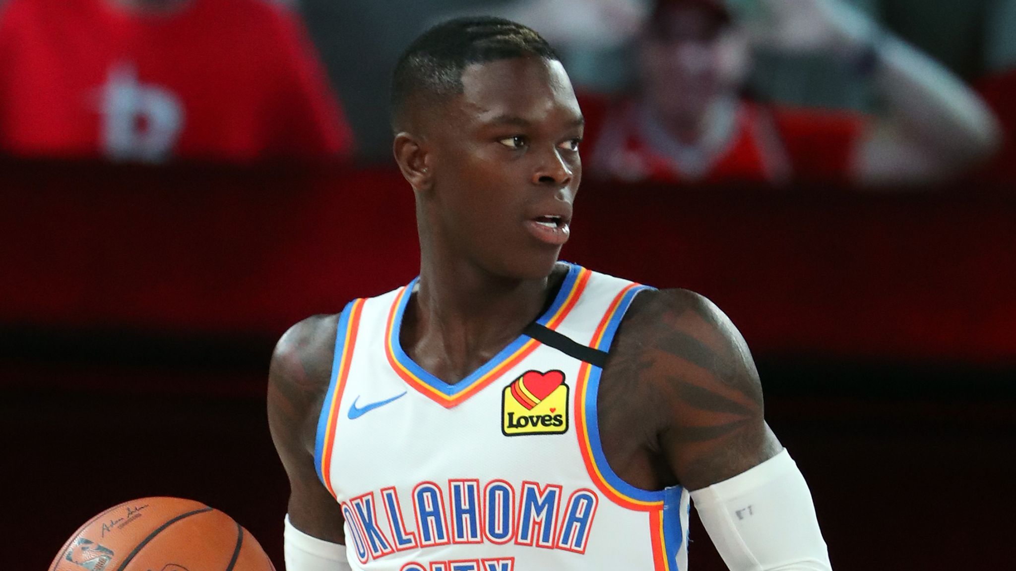 Dennis Schroder driving to the basket in an Oklahoma City Thunder uniform during an NBA game.