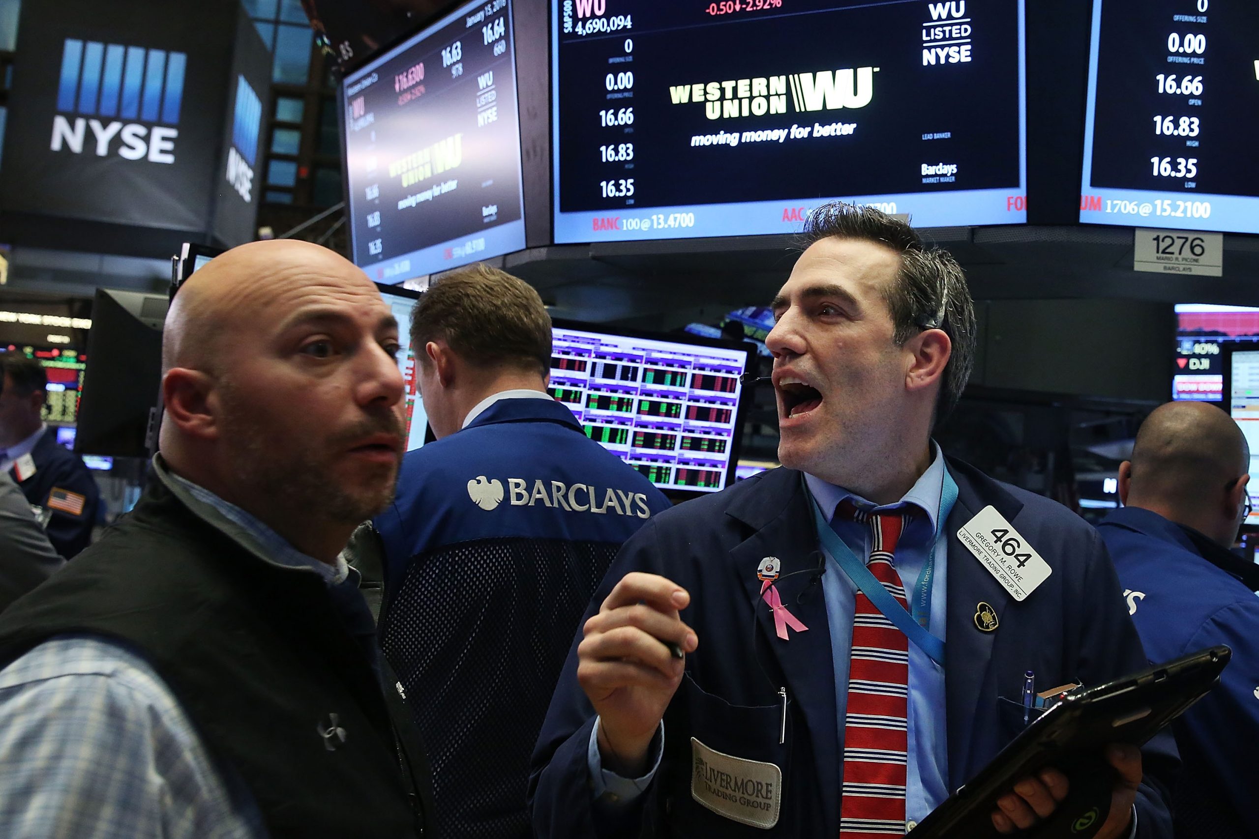 Traders react on the New York Stock Exchange floor as tech stocks slide during an AI-driven market sell-off