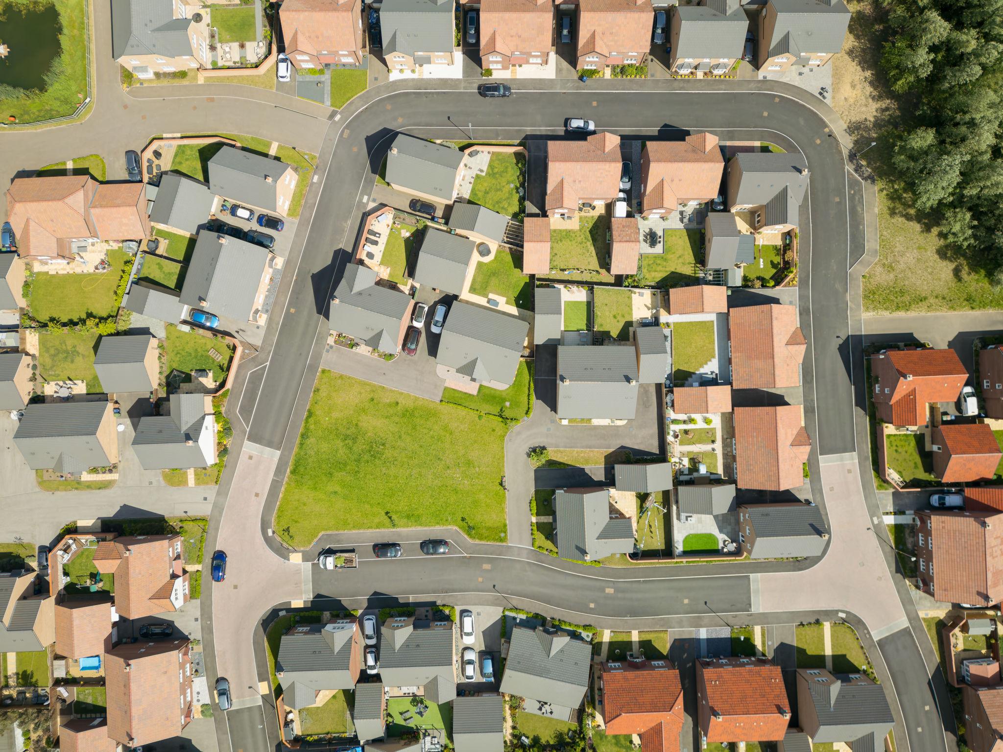 Aerial view of UK residential housing estate illustrating property tax and second home surcharge rules