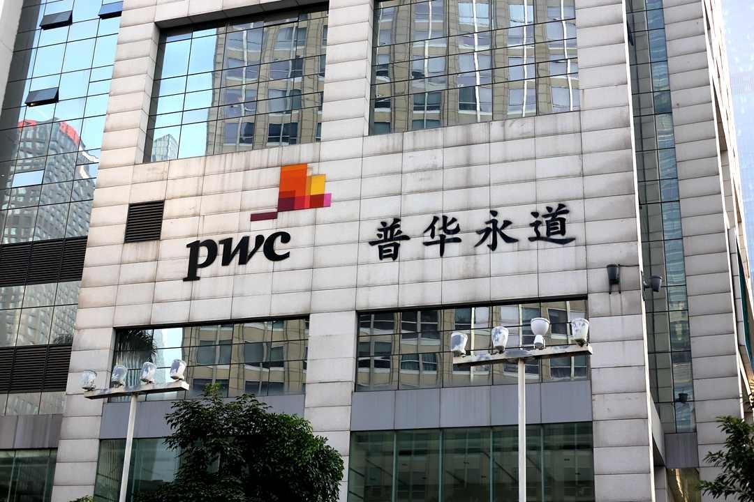 PwC office building with logo after Evergrande audit scandal and $166 million fine