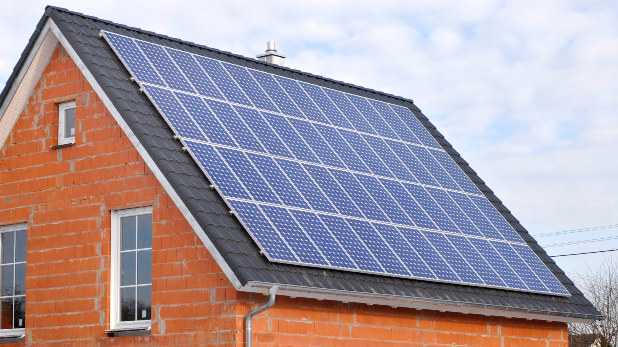 UK home with rooftop solar panels as households switch to cut rising energy bills