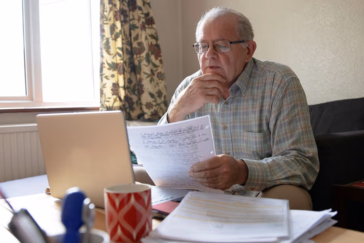 Older British man checking pension documents