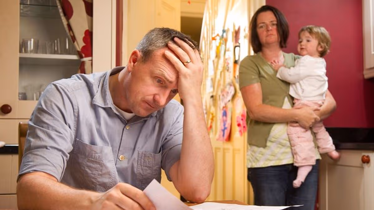 Family reviewing bills as Federal Reserve warns interest rates may stay high
