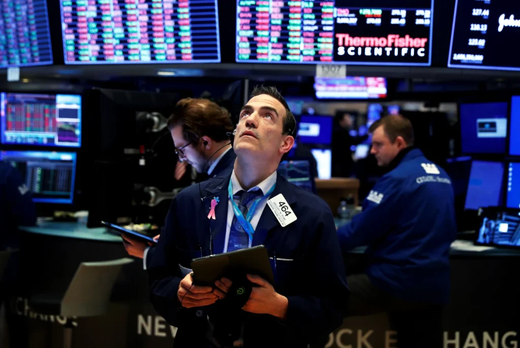Wall Street traders react as rising bond yields and inflation fears increase pressure on stocks