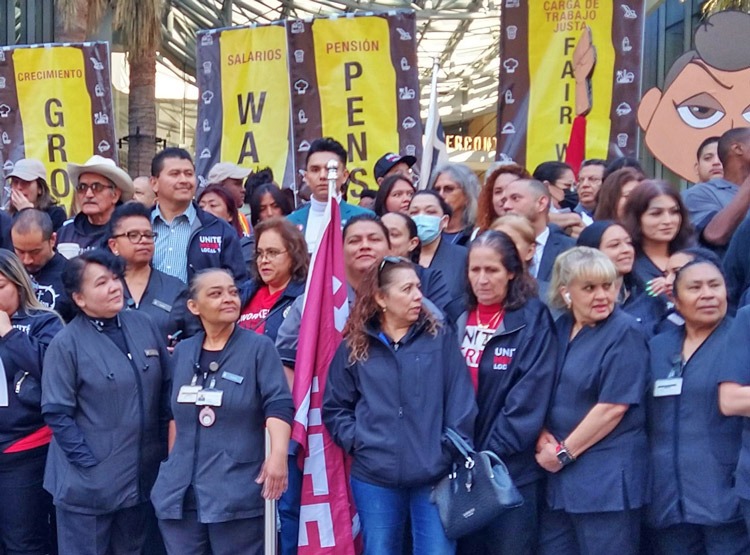 Hotel and airport workers protesting outside Los Angeles City Hall over minimum wage delays