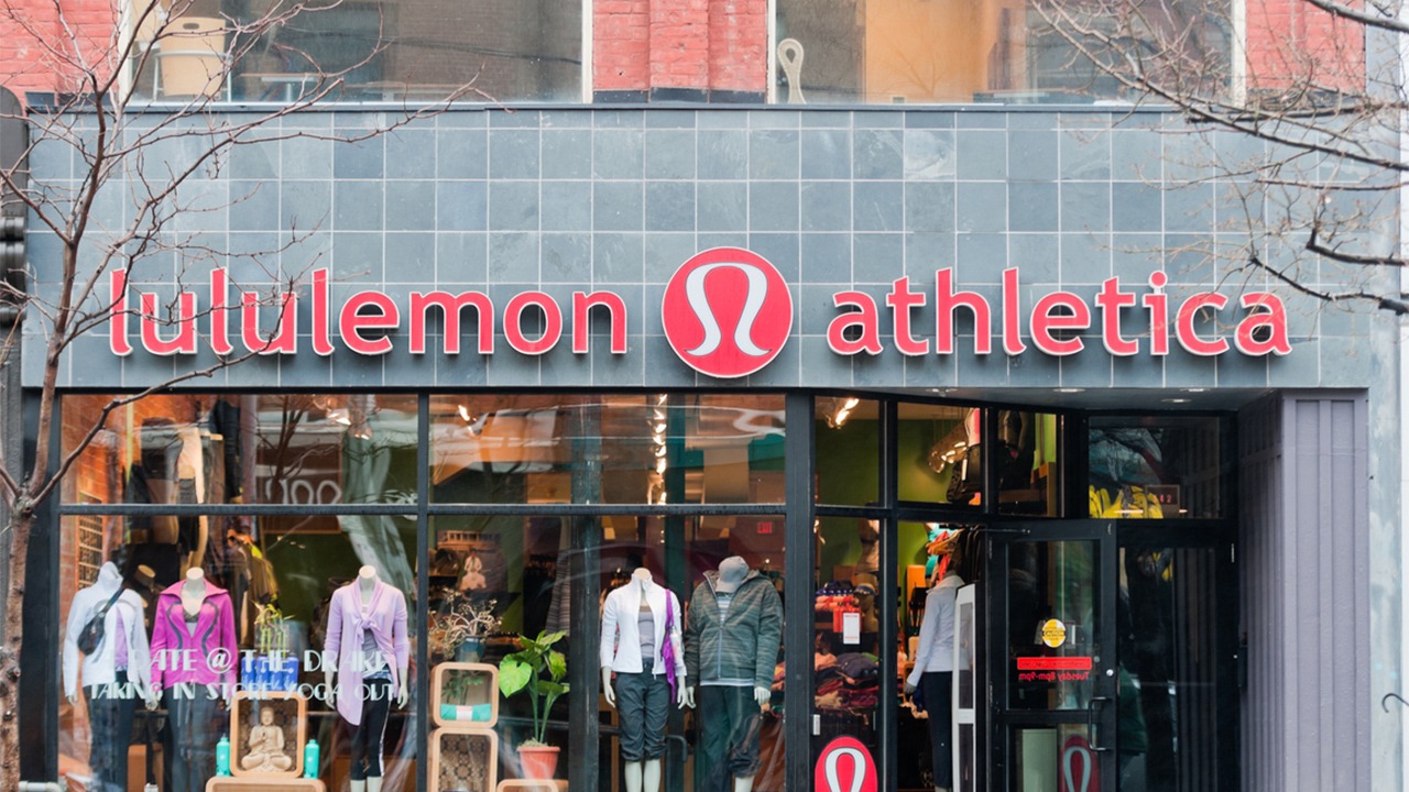 Shoppers outside a Lululemon store as concerns grow about slowing consumer spending and weakening retail demand.