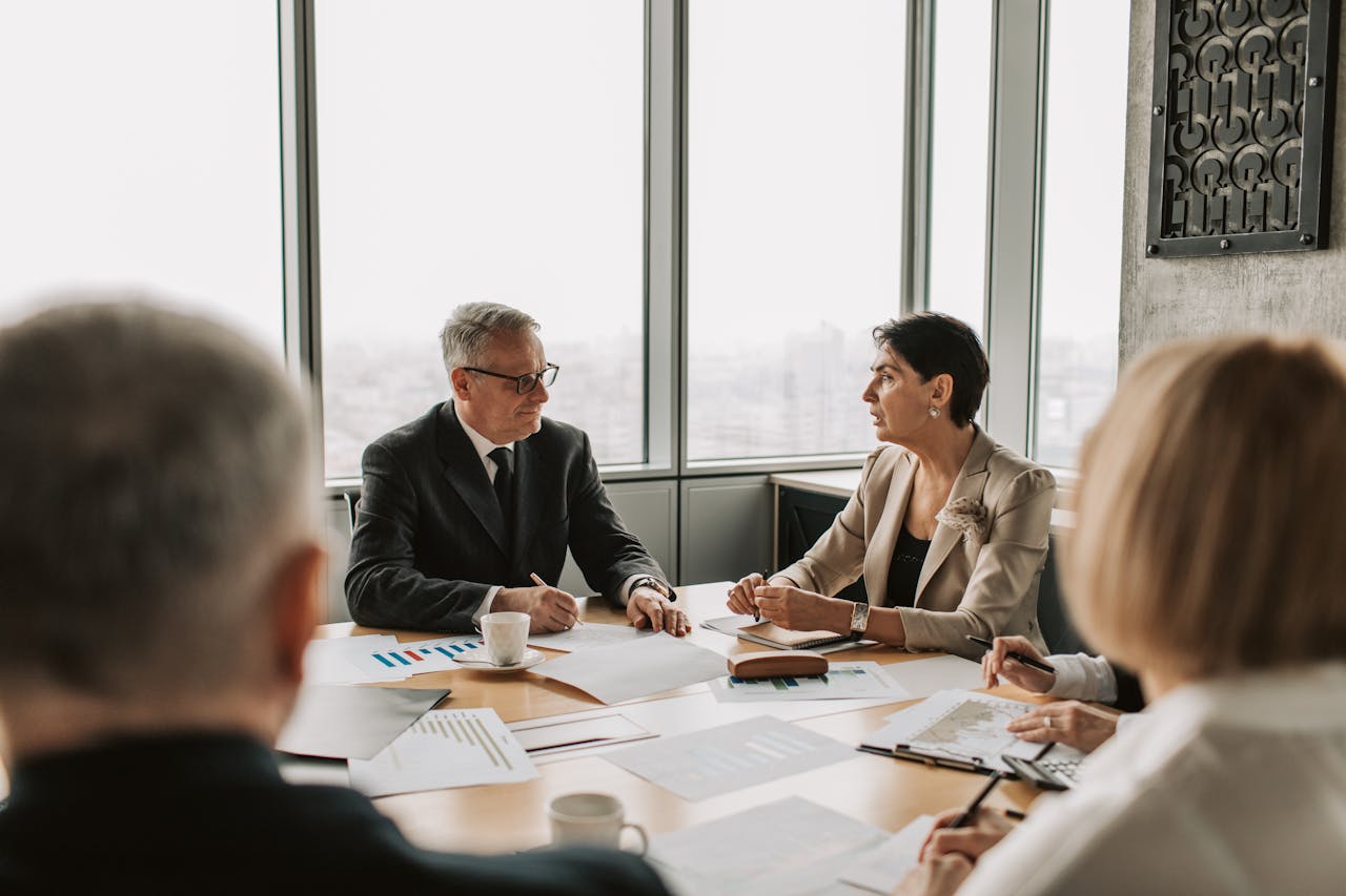 A corporate finance team in a boardroom planning a merger