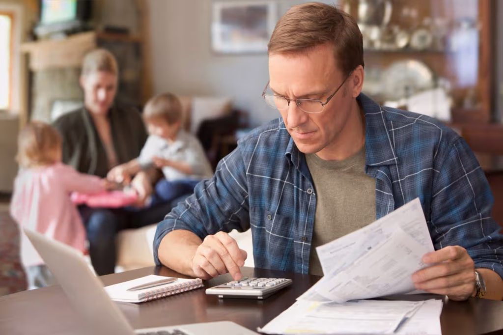 Family reviewing tax documents while managing household expenses.