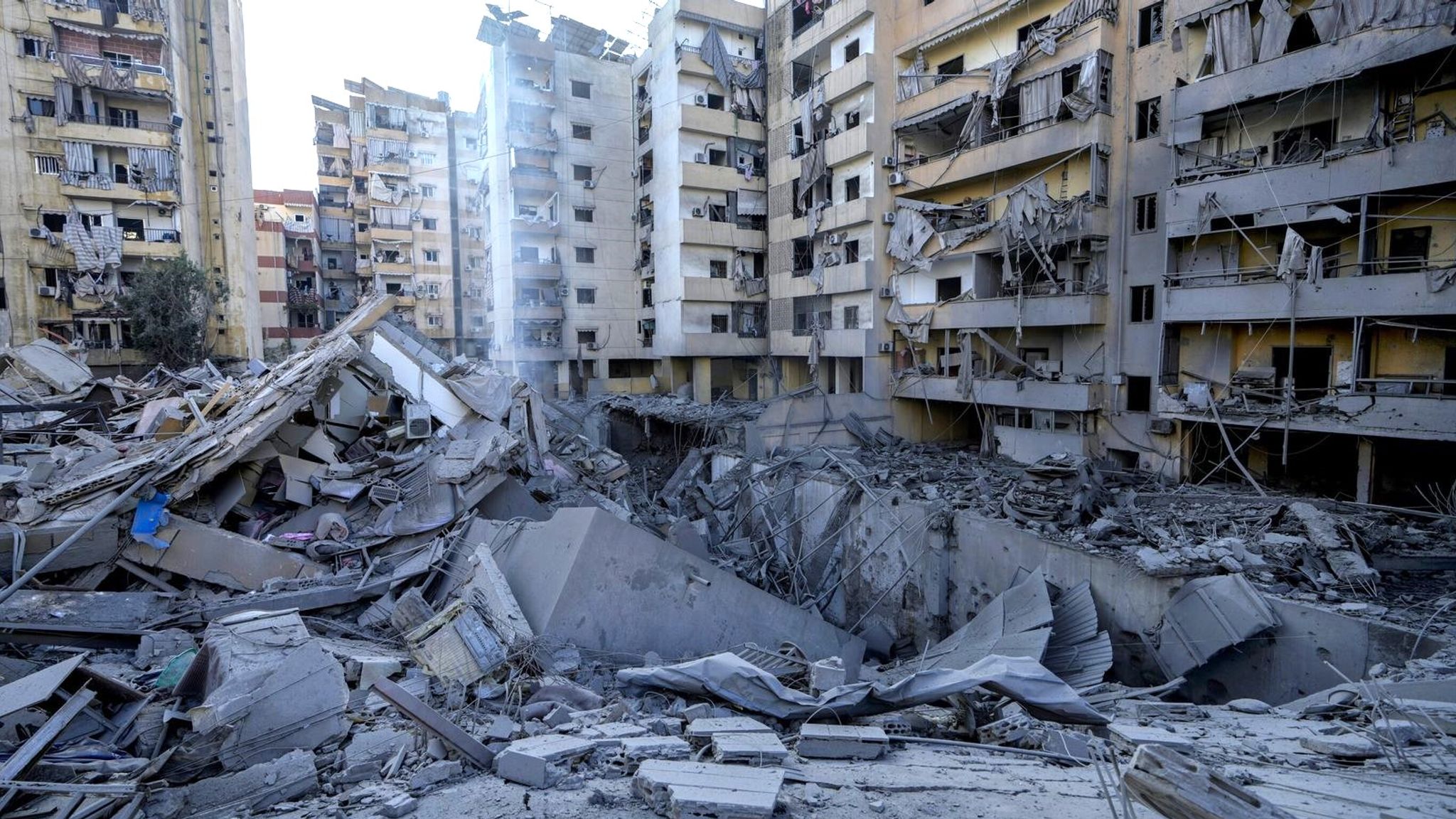 Damaged buildings and debris in Beirut's southern suburbs following Israeli airstrikes.